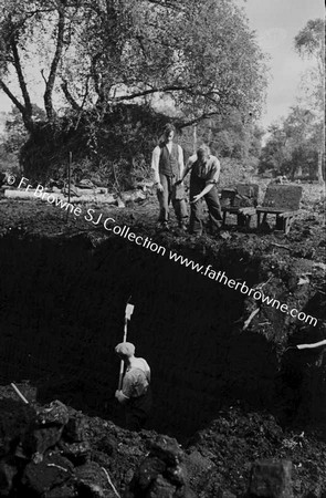 MEN DIGGING PEAT BY HAND